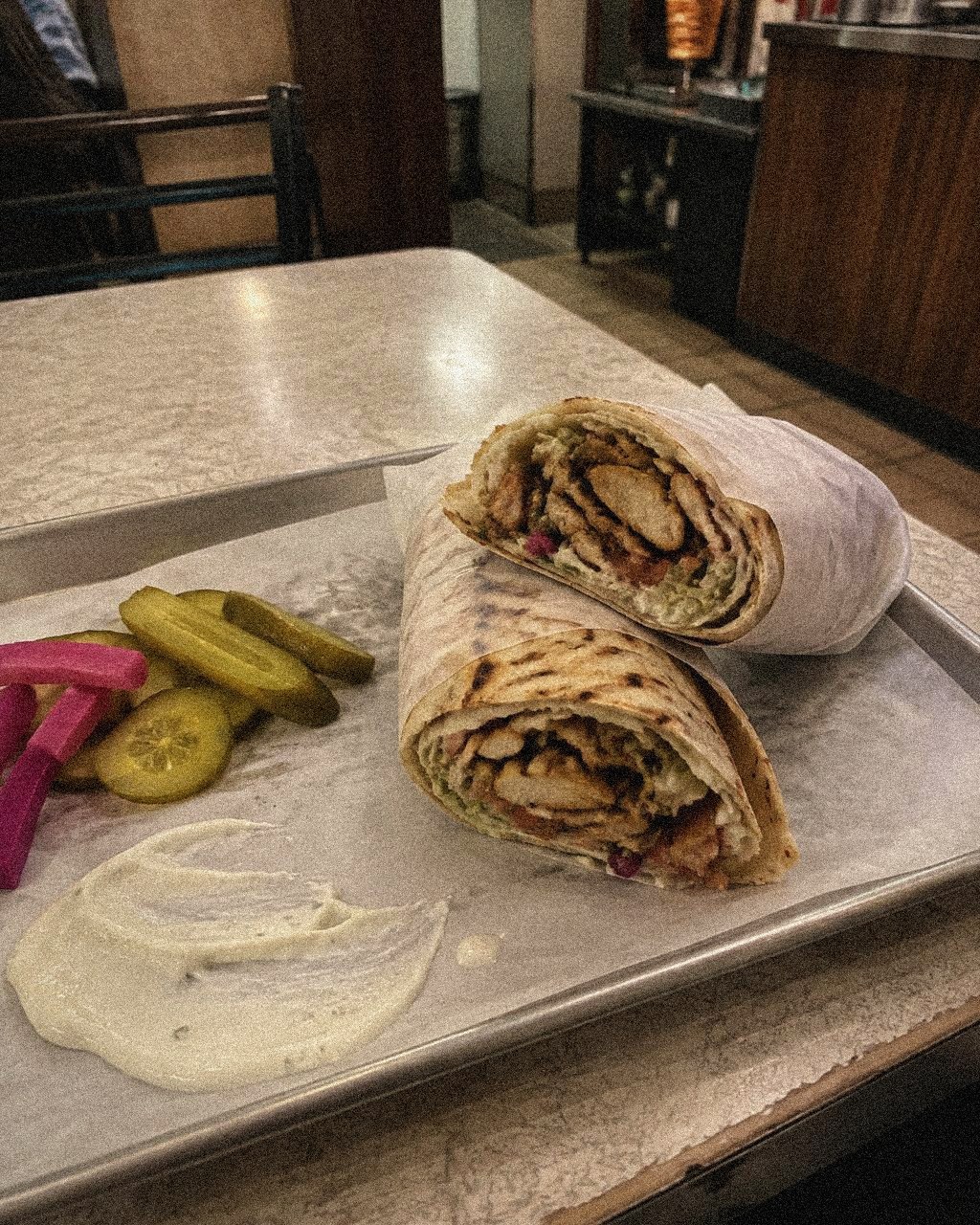 Chicken shawarma wrap with pickles and garlic sauce